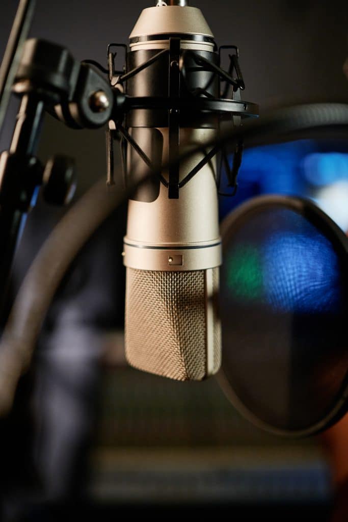 Microphone with pop filter in modern recording studio